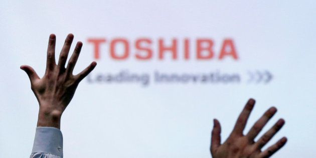 Reporters raise their hands for a question during a news conference by Toshiba Corp CEO Satoshi Tsunakawa (not in picture) at the company headquarters in Tokyo, Japan June 23, 2017. REUTERS/Issei Kato