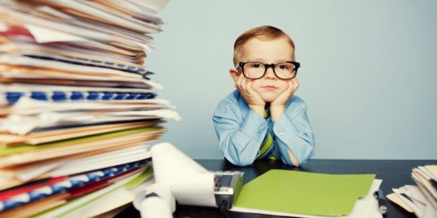 A young boy accountant has too much work to do at the office. Too much stress this tax season.