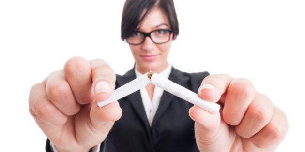 Business woman breaking a cigarette in half. Stop or quit smoking concept.
