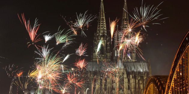 Fireworks light up the Dom church on the Rhine river in Cologne, western Germany after midnight on January 1, 2013, as part of the New Year celebrations. AFP PHOTO / PATRIK STOLLARZ (Photo credit should read PATRIK STOLLARZ/AFP/Getty Images)