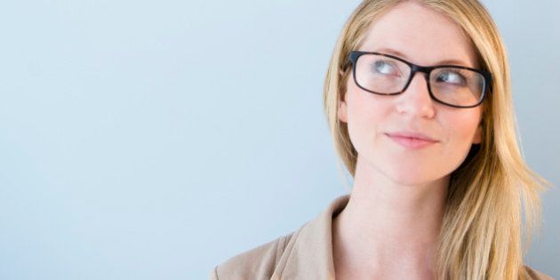 Woman wearing glasses looking up