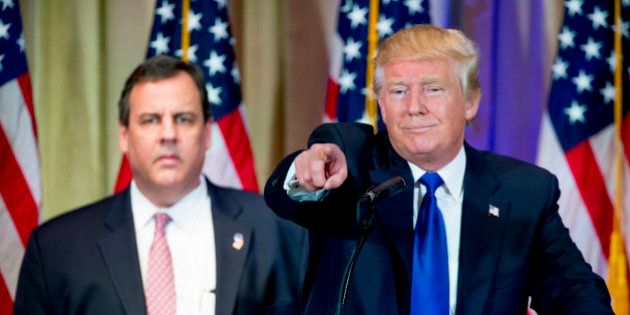 Republican presidential candidate Donald Trump, accompanied by New Jersey Gov. Chris Christie, left, takes questions from members of the media during a news conference on Super Tuesday primary election night in the White and Gold Ballroom at The Mar-A-Lago Club in Palm Beach, Fla., Tuesday, March 1, 2016. (AP Photo/Andrew Harnik)
