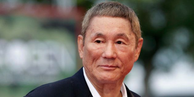 Japanese director Takeshi Kitano poses on the red carpet for the movie
