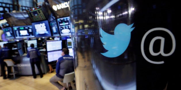 The Twitter logo appears on a phone post on the floor of the New York Stock Exchange, Tuesday, Oct. 13, 2015. Twitter is laying off up to 336 employees, signaling CEO Jack Dorsey's resolve to slash costs while the company struggles to make money. (AP Photo/Richard Drew)