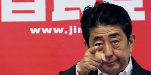 Japanese Prime Minister and leader of the ruling Liberal Democratic Party, Shinzo Abe, points a reporter for questions during a press conference in Tokyo, Monday, July 11, 2016. A resounding election victory for Abeâs ruling bloc has opened the door a crack for his long-cherished ambition to revise the constitution for the first time since it was enacted in 1947 - a behind-the-scenes agenda that could over time change Japanâs future. (AP Photo/Koji Sasahara)