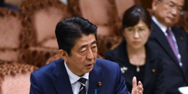 Japan's Prime Minister Shinzo Abe (L) answers questions during a budget dommittee meeting in the Upper House at parliament in Tokyo on July 25, 2017, as he and other relevant ministers were expected to face more questioning over issues over a suspected scandal.For months Abe has been dogged by scandals, most recently claims he showed favouritism to a friend in a business deal, an accusation he denies. / AFP PHOTO / Kazuhiro NOGI (Photo credit should read KAZUHIRO NOGI/AFP/Getty Images)