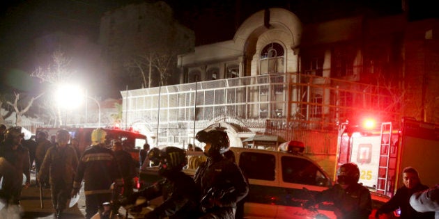 Iranian security protect Saudi Arabia's embassy in Tehran, Iran, while a group of demonstrators gathered to protest execution of a Shiite cleric in Saudi Arabia, Sunday, Jan. 3, 2016. (AP Photo/Ebrahim Noroozi)