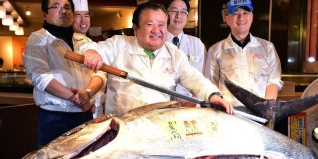 President of sushi restaurant chain Sushi-Zanmai, Kiyoshi Kimura, displays a 200kg bluefin tuna at his main restaurant near Tokyo's Tsukiji fish market on January 5, 2016. The bluefin tuna was traded at 117,000 USD (14 million yen) at the wholesale market on the first trading day of the new year. Tsukiji market will close its doors after 80 years followed by a new market opening in Toyosu this autumn. AFP PHOTO / Yoshikazu TSUNO / AFP / YOSHIKAZU TSUNO (Photo credit should read YOSHIKAZU TSUNO/AFP/Getty Images)