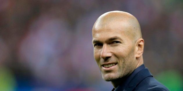 Former France's soccer player Zinedine Zidane smiles prior the international friendly soccer match between France and Brazil at the Stade de France, north of Paris, France, Thursday, March 26, 2015. (AP Photo/Francois Mori)