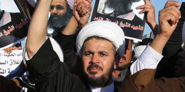 Iraqi Shiite protesters chant slogans against the Saudi government as they hold posters showing Sheikh Nimr al-Nimr, who was executed in Saudi Arabia last week, during a demonstration in Najaf, 100 miles (160 kilometers) south of Baghdad, Iraq, Monday, Jan. 4, 2016. Demonstrations against the al-Nimr execution and Saudi Arabia are also being called for in the predominantly Shiite southern cities on Monday. (AP Photo/Karim Kadim)