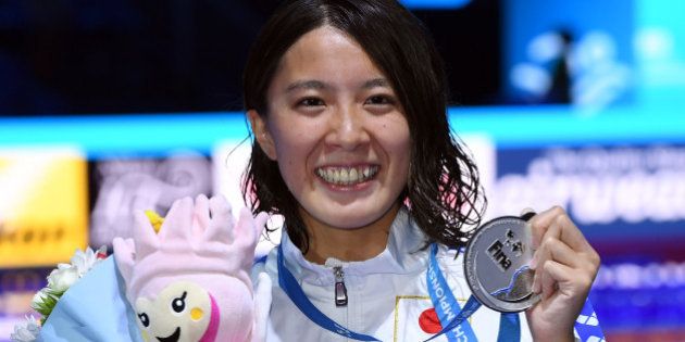 Japan's Yui Ohashi celebrates on the podium after the women's 200m Individual Medley final during the swimming competition at the 2017 FINA World Championships in Budapest, on July 24, 2017. / AFP PHOTO / ATTILA KISBENEDEK (Photo credit should read ATTILA KISBENEDEK/AFP/Getty Images)