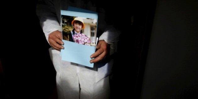 Norio Kimura, 50, who lost his father, wife and younger daughter in the March 11, 2011 tsunami, poses with a portrait of his missing daughter Yuna at a temple near his home inside the exclusion zone in Okuma, near Tokyo Electric Power Co's (TEPCO) tsunami-crippled Fukushima Daiichi nuclear power plant, Fukushima Prefecture, Japan, February 14, 2016. Survivors exposed themselves to high levels of radiation five years ago while searching for family members swept away by the tsunami that triggered meltdowns at Japanâs Fukushima nuclear plant. The disaster in March 2011 killed nearly 16,000 people along Japan's northeastern coast and left more than 2,500 missing. Family members continue to look for the bodies of their missing loved ones, when access to the area is permitted, as they still try to bring closure to their loss. REUTERS/Toru Hanai SEARCH