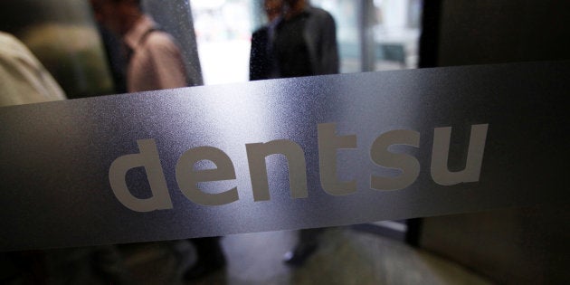 The logo of Dentsu Co. is seen at the entrance of the company headquarters in Tokyo July 12, 2012. REUTERS/Issei Kato/File photo