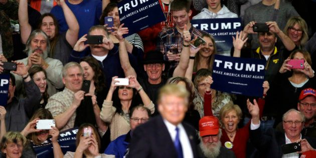 Supporters reacts as Republican presidential candidate Donald Trump speaks during a campaign rally at Clinton Middle School, Saturday, Jan. 30, 2016, in Clinton, Iowa. (AP Photo/Charlie Neibergall)