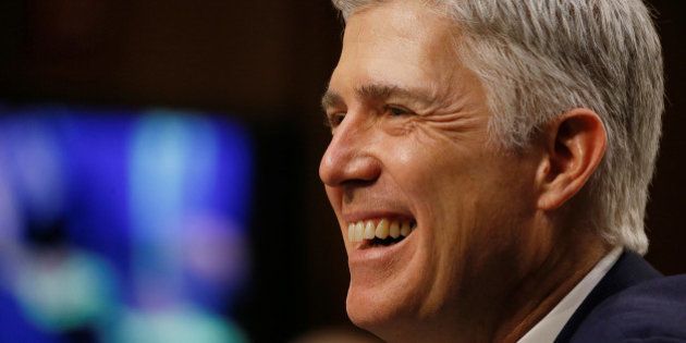 U.S. Supreme Court nominee judge Neil Gorsuch smiles in reaction to a question as he testifies during the third day of his Senate Judiciary Committee confirmation hearing on Capitol Hill in Washington, U.S., March 22, 2017. REUTERS/Jim Bourg