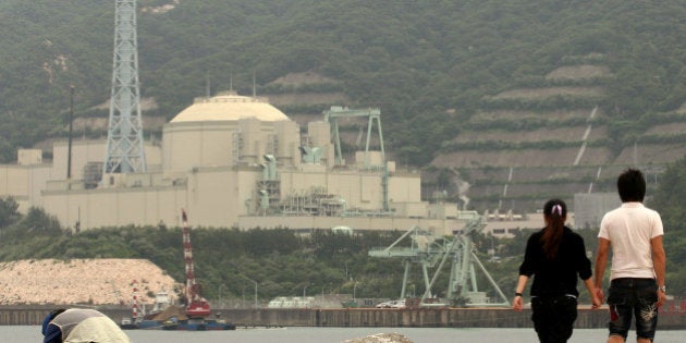 TSURUGA, JAPAN - JUNE 10: A couple walk beside the Monju nuclear reactor, one day before the three month anniversary of Japan's earthquake and tsunami on June 10, 2011 in Tsuruga, Japan. The Japanese government has been struggling to deal with the devastation caused by the magnitude 9 earthquake and tsunami, as well as the troubled Fukushima Daiichi Nuclear Power Plant. The fears of an outbreak of infectious diseases are mounting due to the impending humid rainy season combined with the delay in clearing the debris. (Photo by Buddhika Weerasinghe/Getty Images)