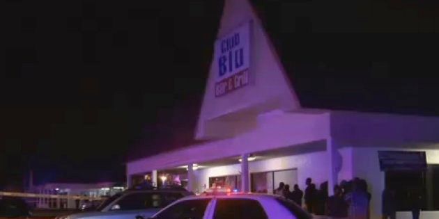 In this frame from video, people gather near the scene of a fatal shooting at Club Blu nightclub in Fort Myers, Fla., Monday, July 25, 2016. (WBBH via AP)