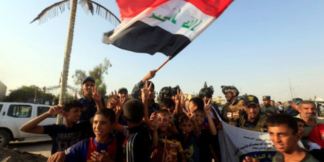Iraqi Federal police and boys celebrate in West Mosul, Iraq July 9, 2017. REUTERS/Alaa Al-Marjani