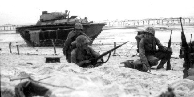 Marines moving along the beach cautiously while an amphibious tank covers them, Peleliu, Palau, September 1944. (Photo by PhotoQuest/Getty Images)