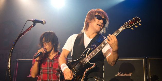NEW YORK, NY - SEPTEMBER 30: Koshi Inaba and Tak Matsumoto (R) of B'z perform on stage at Best Buy on September 30, 2012 in New York, United States. (Photo by Daniel Boczarski/Redferns via Getty Images)