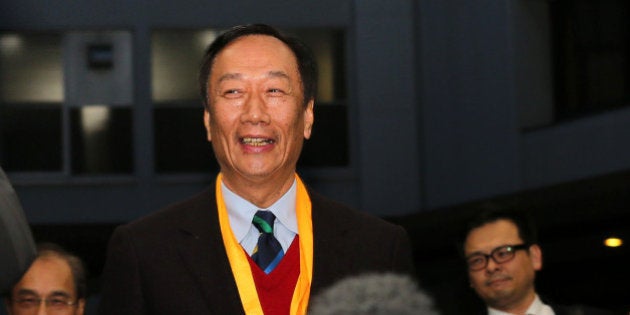 Terry Gou, chairman of Foxconn Technology Group, arrives at a podium before he speaks to media at the Sharp Corp. headquarters in Osaka, Japan on Friday, Feb 5, 2016. Gou took a step forward in the hotly contested battle for control of Japans Sharp Corp., winning an agreement to become the preferred negotiating partner for a bailout of the struggling consumer electronics maker. Photographer: Buddhika Weerasinghe/Bloomberg via Getty Images