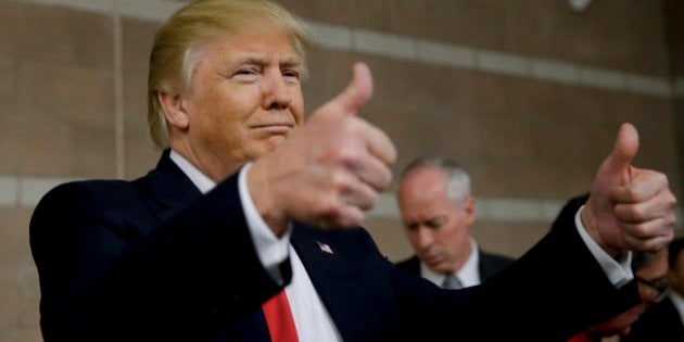 Republican presidential candidate Donald Trump greets supporters at a caucus site, Tuesday, Feb. 23, 2016, in Las Vegas. (AP Photo/Jae C. Hong)