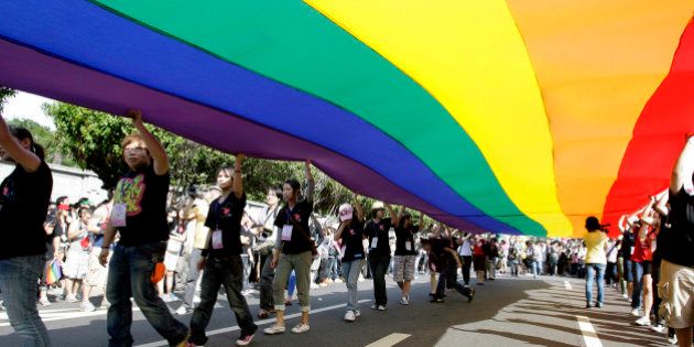 Participants hold a rainbow flag during the Taiwan Gay Pride Parade in Taipei October 31, 2009. Around 25,000 Taiwanese gathered with people from countries including Malaysia, Korea and Japan on Saturday for the annual gay pride parade which is in its seventh year, according to organisers. REUTERS/Pichi Chuang (TAIWAN SOCIETY)