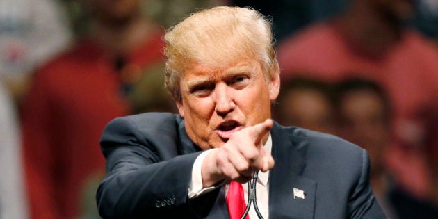 FILE - In this Feb. 26, 2016, file photo, Republican presidential candidate Donald Trump gestures during a speech at a rally in Oklahoma City. Democrats increasingly view Trump as the likely Republican nominee and are seeking consensus on the best way to challenge the billionaire's unpredictable appeal in a general election. (AP Photo/Sue Ogrocki, File)