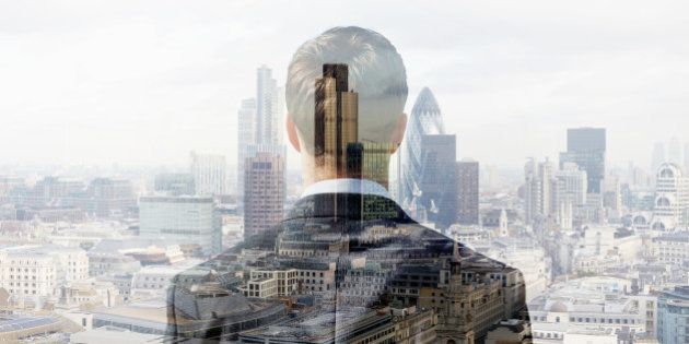 Double exposure of a business man looking towards the financial district of the City of London with the Heron Tower, Tower 42 and the Gherkin.