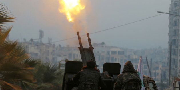 Free Syrian Army fighters fire an anti-aircraft weapon in a rebel-held area of Aleppo, Syria December 12, 2016. REUTERS/Abdalrhman Ismail