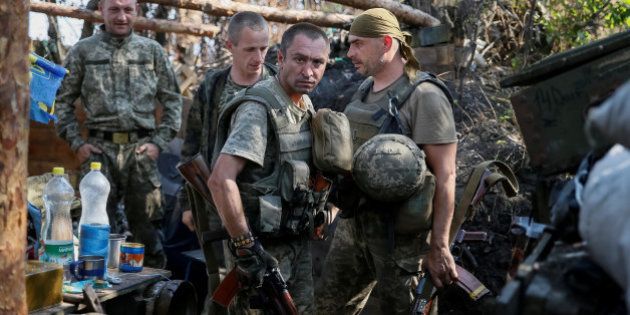 Ukrainian servicemen are seen at their positions on the front line in Krasnogorivka near Donetsk, Ukraine, August 12, 2016. REUTERS/Gleb Garanich