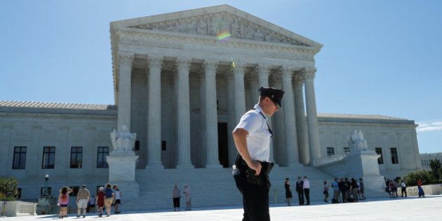 A police officer stands outside the U.S. Supreme Court building after the Court sided with Trinity Lutheran Church, which objected to being denied public money in Missouri, in Washington, U.S., June 26, 2017. REUTERS/Yuri Gripas
