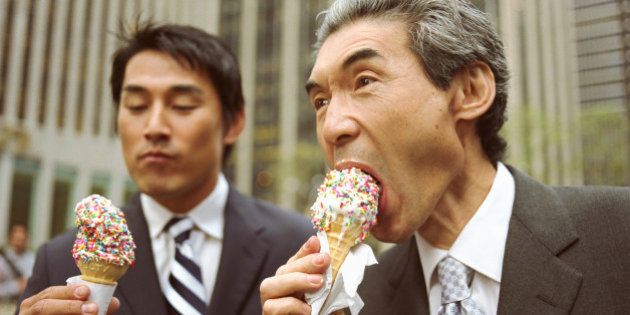 Two businessmen eating ice cream