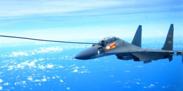 GUANGZHOU, Sept. 13, 2016 -- A Chinese Air Force Su-30 fighter is refueled during a routine combat simulation drill over the West Pacific Sept. 12, 2016. The Chinese Air Force on Monday sent multiple aircraft models, including H-6K bombers, Su-30 fighters, and air tankers, for the drill. The fleet conducted reconnaissance and early warning, sea surface cruising, inflight refueling, and achieved all the drill's targets. (Xinhua/Xiao Jianjun via Getty Images)