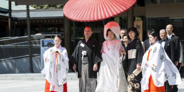 Japanese bride and groom with family and shrine maidens (Miko) at Shinto wedding ceremony, Meiji Jingu shrine, Tokyo, Japan