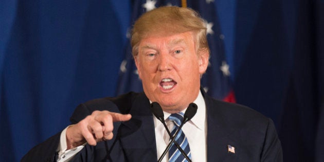 Republican presidential candidate Donald Trump reads from a statement about Pope Francis during a campaign rally in Kiawah, South Carolina, February 17, 2016. Trump cannot claim to be a Christian, Pope Francis said Thursday, after the billionaire vowed to build a border wall to keep out immigrants. 'Anyone, whoever he is, who only wants to build walls and not bridges is not a Christian,' the pontiff told journalists during his return journey from a trip to Mexico in response to a question about Trump's anti-immigrant stance. / AFP / JIM WATSON (Photo credit should read JIM WATSON/AFP/Getty Images)