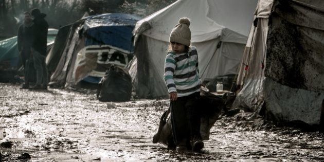 A child walks in the so-called 'Jungle' migrant camp in Gande-Synthe where 2,500 refugees from Kurdistan, Iraq and Syria live on February 11, 2016 in Grande-Synthe near the city of Dunkirk, northern France. / AFP / PHILIPPE HUGUEN (Photo credit should read PHILIPPE HUGUEN/AFP/Getty Images)