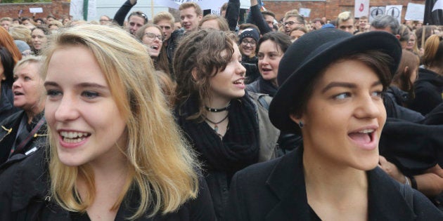 Polish women shout slogans during a nationwide strike and demonstration to protest a legislative proposal for a total ban on abortion in Warsaw, Poland, Monday, Oct. 3, 2016. Polish women are waging a nationwide strike with workers and students boycotting their jobs and classes and housewives refusing to do housework. (AP Photo/Czarek Sokolowski)