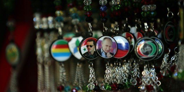 Key-rings bearing portraits of Syrian President Bashar al-Assad (L) and his Russian counterpart Vladimir Putin (C) are displayed at a handicrafts shop in the Syrian capital, Damascus, on February 4, 2016. Syrian government troops moved closer to encircling rebels in the country's second city Aleppo, threatening a total siege after cutting their main supply line. / AFP / JOSEPH EID (Photo credit should read JOSEPH EID/AFP/Getty Images)