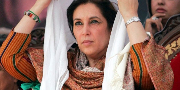 Former Pakistani Prime Minister Benazir Bhutto adjusts her scarf at a campaign rally in Pabbi, 120 kilometers (75 miles) west of Islamabad, Pakistan, Wednesday Dec. 12, 2007. Bhutto repeated accusations that Musharraf will try to cheat by using police, judiciary officials and administration functionaries. (AP Photo/Greg Baker)