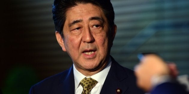 Japanese Prime Minister SHinzo Abe speaks to reporters at his official residence in Tokyo on September 8, 2015. Abe extended his term as party leader, putting himself potentially on course to the longest-serving premier in Japanese politics in decades. AFP PHOTO / POOL / Yoshikazu TSUNO (Photo credit should read YOSHIKAZU TSUNO/AFP/Getty Images)