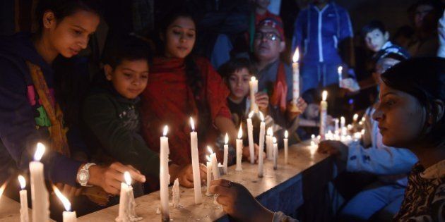 Activists of Pakistan Tehreek e Insaaf (PTI) light candles for the victims of an attack by Taliban gunmen on a school in Peshawar, in Karachi on December 16, 2014. Taliban insurgents killed at least 130 people, most of them children, after storming an army-run school in one of Pakistan's bloodiest ever attacks. AFP PHOTO / Asif HASSAN (Photo credit should read ASIF HASSAN/AFP/Getty Images)