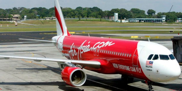 An AirAsia plane taxis on the runway after landing at Singapore's Changi International Airport Friday, Feb. 1, 2008 in Singapore. Much-awaited budget flights between Singapore and the Malaysian city of Kuala Lumpur started Friday, ending the decades-old virtual duopoly of the lucrative route by the two countries' flag carriers. It was a move analysts believe would increase demand on the route - already Asia's fourth busiest - and spur other Southeast Asian nations to speed up efforts to liberalize the region's air services. (AP Photo/Wong Maye-E)