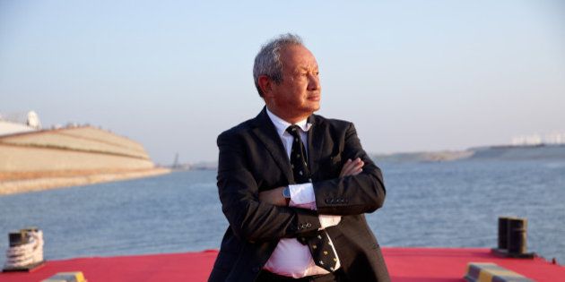 Egyptian billionaire Naguib Sawiris poses for a photograph on a floating pontoon in front of the New Suez Canal, operated by the Suez Canal Authority, in Ismailia, Egypt, on Thursday, Aug. 6, 2015. The expansion will meet future demand, with traffic expected to double to 97 vessels a day by 2023, said Mohab Mameesh, head of the Suez Canal Authority. Photographer: Shawn Baldwin/Bloomberg via Getty Images