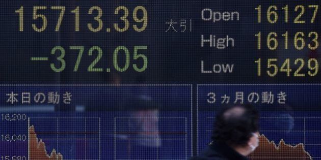A man walks past an electric quotation board flashing the Nikkei key stock index of the Tokyo Stock Exchange (TSE) in front of a securities company in Tokyo on February 10, 2016. Tokyo stocks again dropped on February 10 to their lowest level since late 2014, as fears of a global recession hammered investor confidence ahead of testimony by the head of the US central bank. AFP PHOTO / Toru YAMANAKA / AFP / TORU YAMANAKA (Photo credit should read TORU YAMANAKA/AFP/Getty Images)