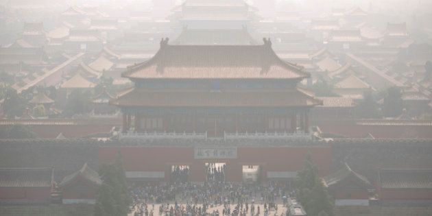 Tourists exit the Forbidden City on a day with high levels of air pollution in Beijing, Monday, Oct. 3, 2016. Saturday was China's National Day holiday, the start of a weeklong holiday period during which millions of Chinese travel and visit tourist sites. (AP Photo/Mark Schiefelbein)