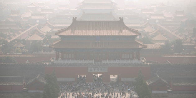 Tourists exit the Forbidden City on a day with high levels of air pollution in Beijing, Monday, Oct. 3, 2016. Saturday was China's National Day holiday, the start of a weeklong holiday period during which millions of Chinese travel and visit tourist sites. (AP Photo/Mark Schiefelbein)