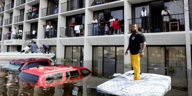 New Orleans Police and volunteers use boats to rescue residents from a flooded neighborhood on the east side of New Orleans, Wednesday, Aug. 31, 2005. Hurricane Katrina left much of the city under water. Officials called for a mandatory evacuation of the city, but many resident remained in the city and had to be rescued from flooded homes and hotels. (AP Photo/Eric Gay)