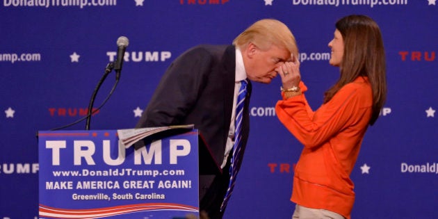 Republican presidential candidate Donald Trump has a supporter, Mary Margaret Bannister, check to see if his hair is real during his speech to supporters during a rally at the TD Convention Center, Thursday, Aug. 27, 2015, in Greenville, S.C. (AP Photo/Richard Shiro)