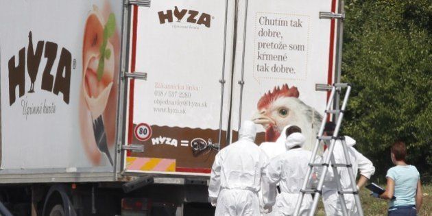 Forensic officers stand in front of a truck inside which were found a large number of dead migrants on a motorway near Neusiedl am See, Austria, on August 27, 2015. The vehicle, which contained between 20 and 50 bodies, was found on a parking strip off the highway in Burgenland state, police spokesman Hans Peter Doskozil said at a press conference with Interior Minister Johanna Mikl-Leitner. AFP PHOTO / DIETER NAGL (Photo credit should read DIETER NAGL/AFP/Getty Images)